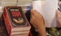 (FILES) This file photo taken on July 15, 2015 shows a boy reading a book next to copies of British writer George Orwell's "1984" at Hong Kong's annual book fair. Amid a seemingly endless battle with the new US president over truth and untruth, George Orwell's "1984" has become a best-seller again. The dystopian novel featuring a so-called "ministry of truth" that distorts reality was the number one seller on Amazon's US book list on January 25, 2017. / AFP PHOTO / aaron tamAARON TAM/AFP/Getty Images