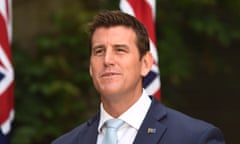 white man in suit and tie with australia flag badge on lapel