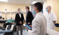 The Greek prime minister, Kyriakos Mitsotakis, meeting staff at the hospital in Ikaria island