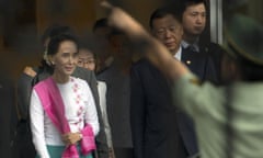 Aung San Suu Kyi, left, Burma’s opposition leader, arrives at Beijing airport