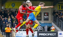 Torquay’s Aaron Jarvis (right) jumps with Emmanuel Onariase and Harry Phipps of Dagenham & Redbridge in the National League.