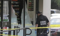 A crime scene investigator examines a shot-out window in Dallas on Friday 8 July 2016