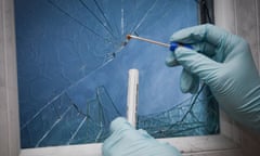 A CSI (Crime Scene Investigator) swabbing blood left at a crime scene.