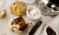 A cream tea in the restaurant at the National Trust’s Sissinghurst Castle Garden in Kent, with a pot of tea, fruit scones, clotted cream and jam.