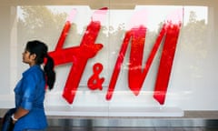 Inside India’s First A Hennes &amp; Mauritz AB Store As It Opens To The Public<br>A pedestrian walks past a Hennes &amp; Mauritz AB (H&amp;M) logo displayed in the window of the clothing retailer’s store in Select Citywalk mall in the Saket area of New Delhi, India, on Friday, Oct. 2, 2015. The Swedish retailer, which has more than 3,600 outlets worldwide, opened its first store in India today. Photographer: Udit Kulshrestha/Bloomberg via Getty Images