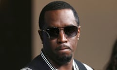 Black man with short black hair and goatee in sunglasses