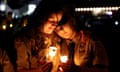 People hold candles during a candlelight vigil for victims of Lewiston mass shooting, in Lisbon, Maine, on 28 October 2023. 