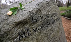 A rose placed on a stone inscribed with the words 'Holocaust Memorial Garden'