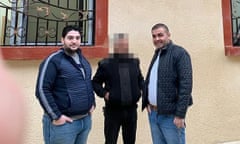 Abdul Rahman Khiti (L) poses with his brother, Syrian MP Amer Khiti (R) in front of a Syrian Ministry of Defence Recruitment Office in Douma. 