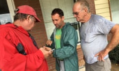 John Utesch, Brad Johns and Wayne Johns, boatmen from Louisiana, discuss rescue sites in Houston.