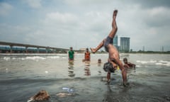 Fishing And Swimming In India's Most Polluted Yamuna River<br>NEW DELHI, INDIA - AUGUST 02: A boy performs a handstand while others watch him while swimming in the polluted river Yamuna on August 2, 2016 in New Delhi, India.

YAMUNA today stands as the most polluted river in India with most of the pollution occurring in the capital city of Delhi. Because of the discharge of industrial effluents and domestic sewage, Delhi is responsible for 80% of the pollution in this river. Despite the toxic capacity of the river, boys from surrounding areas enjoy regular swimming in Yamuna during hot days.

PHOTOGRAPH BY Shams Qari / Barcroft Images

London-T:+44 207 033 1031 E:hello@barcroftmedia.com -
New York-T:+1 212 796 2458 E:hello@barcroftusa.com -
New Delhi-T:+91 11 4053 2429 E:hello@barcroftindia.com www.barcroftimages.com