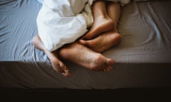 Feet of a couple in bed