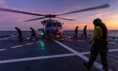 A Seahawk helicopter prepares to take off from the deck of HMAS Hobart