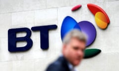 A man passes a British telecom logo