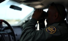 A U.S. border patrol agent keeps watch along the fence next to the Mexican border in Calexico, California, U.S. February 8, 2017. Picture taken February 8, 2017. REUTERS/Mike Blake