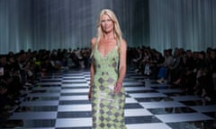 Claudia Schiffer wearing a green chainmail dress on a catwalk