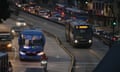 Two buses travel on a main road during a blackout in Quito.