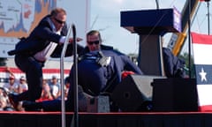 Republican presidential candidate former President Donald Trump is covered by U.S. Secret Service agents on stage at a campaign rally, Saturday, July 13, 2024, in Butler, Pa. (AP Photo/Evan Vucci)