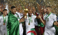 Algerian players including Yacine Brahimi (No 11) and Islam Slimani (No 13) celebrate with the Africa Cup of Nations trophy.