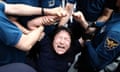 A South Korean protester is detained by police outside the Japanese embassy in Seoul on Thursday after Japan began releasing wastewater from the ruined Fukushima nuclear power plant.