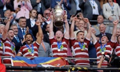 Wigan's captain, Liam Farrell, lifts the Challenge Cup trophy