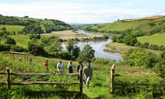 Retreat participants at Sharpham take part in a nature walk with the River Dart in the background