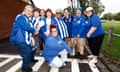 North Melbourne fans pose with North Melbourne’s Tess Craven ahead of the Kangaroos’ prelim final win over Adelaide