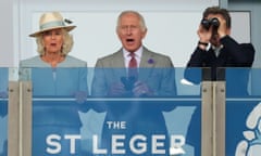 King Charles III and Queen Camilla with racing adviser John Warren watch the action in the St Leger.