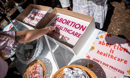 People grab signs reading ‘Abortion is healthcare’ at. a protest outside the Texas state capitol in Austin on 29 May.