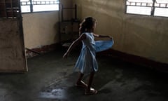 Darianyelis, Juana’s adoptive daughter, plays with her dress inside her home in San Félix, Venezuela, on January 19.