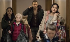 Still from the film Rosie showing the family carrying all their belongings