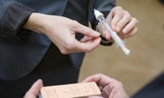 FILE - In this Friday, Feb. 12, 2016, file photo, a naloxone nasal injector is demonstrated during a news conference at the Oakley Kroger Marketplace store, in Cincinnati, to announce the supermarket chain’s decision to offer the opioid overdose reversal medicine without a prescription. It is becoming easier for friends and family of heroin users or patients abusing strong prescription painkillers to get access to naloxone, a powerful, life-saving antidote, as state lawmakers loosen restrictions on the medicine to fight a growing epidemic. (AP Photo/John Minchillo, File)