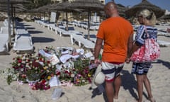Tourists pay their respects at a makeshift memorial in Tunisia to victims of the 2015 terror attack