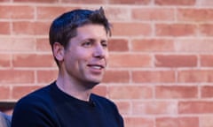 Young white guy with short hair sitting outside next to a brick wall.