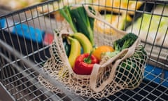 Close-up shot of fruits and vegetables in a mesh grocery bag