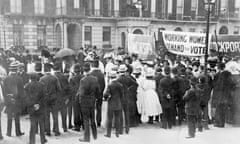 A small crowd watches the Women’s Sunday procession as it passes Portland Place, 21 June 1908.