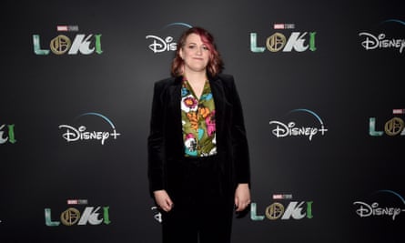 Kate Herron standing against Loki/Disney branding 