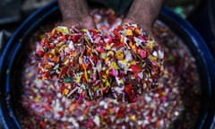 A worker washes shredded plastic waste for recycling