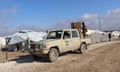 Syrian Democratic Forces fighters take part in a search operation at a refugee camp in north-east Syria on 27 January.