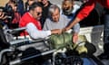 Lotfi Gheith (L), the emergency operations centre director for the Egyptian Red Crescent, briefs United Nations Secretary-General Antonio Guterres (C) about items rejected by Israeli authorities that were bound for the Gaza Strip, at El-Arish International Airport in Egypt's northeastern province of North Sinai