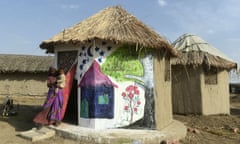 A resident with her flood-resistant hut in Tando Allahyar district in Sindh, Pakistan. The huts are made from bamboo and cost 25,000 rupees (£70) to build.