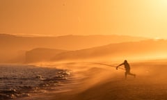 Fishing on Chesil Beach, Dorset at sunset<br>M54YJ3 Fishing on Chesil Beach, Dorset at sunset