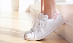 Young woman wearing white trainers<br>MODEL RELEASED. Young woman wearing white trainers on tip toes.