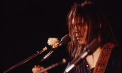 Neil Young with white carnation on his microphone during encore on Time Fades Away tour, unknown location, March 1973
