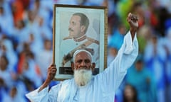 A Pakistani man holds a picture of former president of Pakistan, General Zia-ul-Haq, at the  Wagah border near Lahore, 2010.