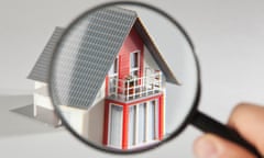 A model house viewed through a magnifying glass<br>A house under a microscope