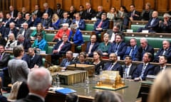 James Cleverly (C right) sitting alongside Britain's Prime Minister Rishi Sunak in the House of Commons, in London, on December 6, 2023