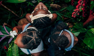 View from above of three African women showing their intricate hairstyles.