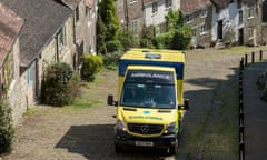 An ambulance on Gold Hill, a scenic rural location in Shaftesbury, Dorset.