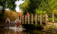 Damien Gabet, far left, cycles through a ford in the countryside at Castle Acre with fellow cyclists on the Rebellion Way trip in Norfolk on a sunny October day.